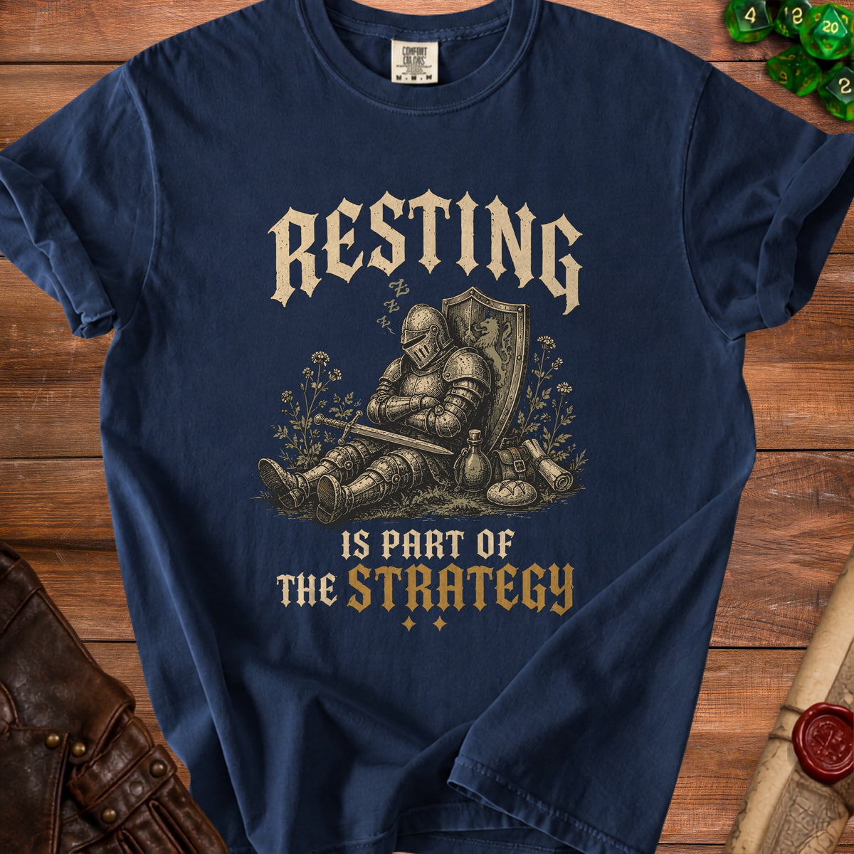 Navy t-shirt with "RESTING IS PART OF THE STRATEGY" and sleeping knight graphic.