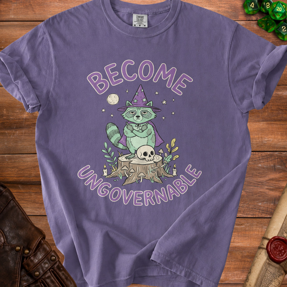 Purple t-shirt with a raccoon in a wizard hat and cape, holding up middle fingers.