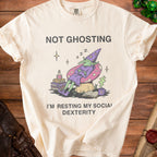 Cream t-shirt with "NOT GHOSTING I'M RESTING MY SOCIAL DEXTERITY" text and goblin graphic.