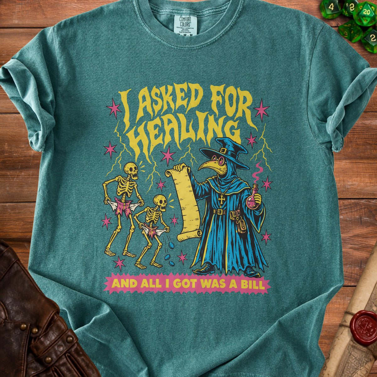 T-shirt with a plague doctor, skeletons, and text "I ASKED FOR HEALING AND ALL I GOT WAS A BILL".