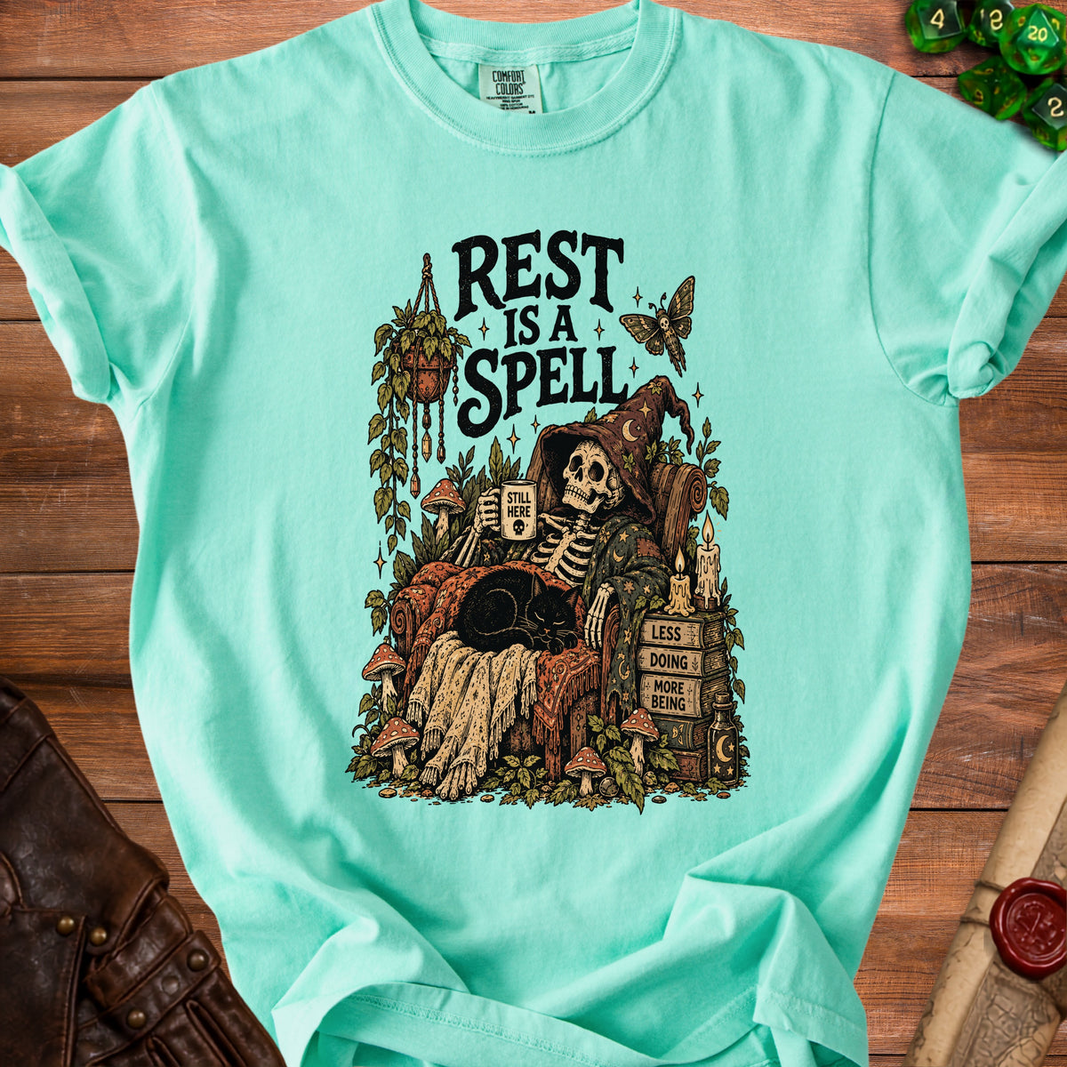 Skeleton in witch hat reading with black cat, "Rest is a Spell" text.