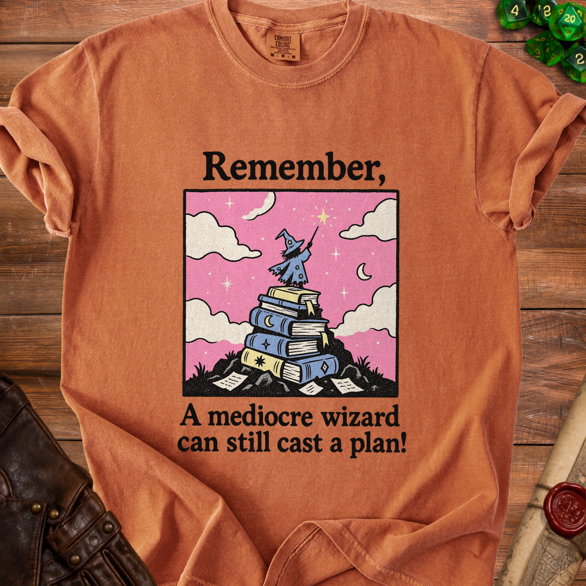 Orange t-shirt with "Remember, A mediocre wizard can still cast a plan!" text.