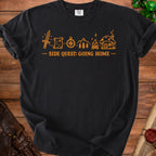 Black t-shirt with orange graphic of sword, map, compass, trees, campfire, and mushroom house with text "SIDE QUEST: GOING HOME".