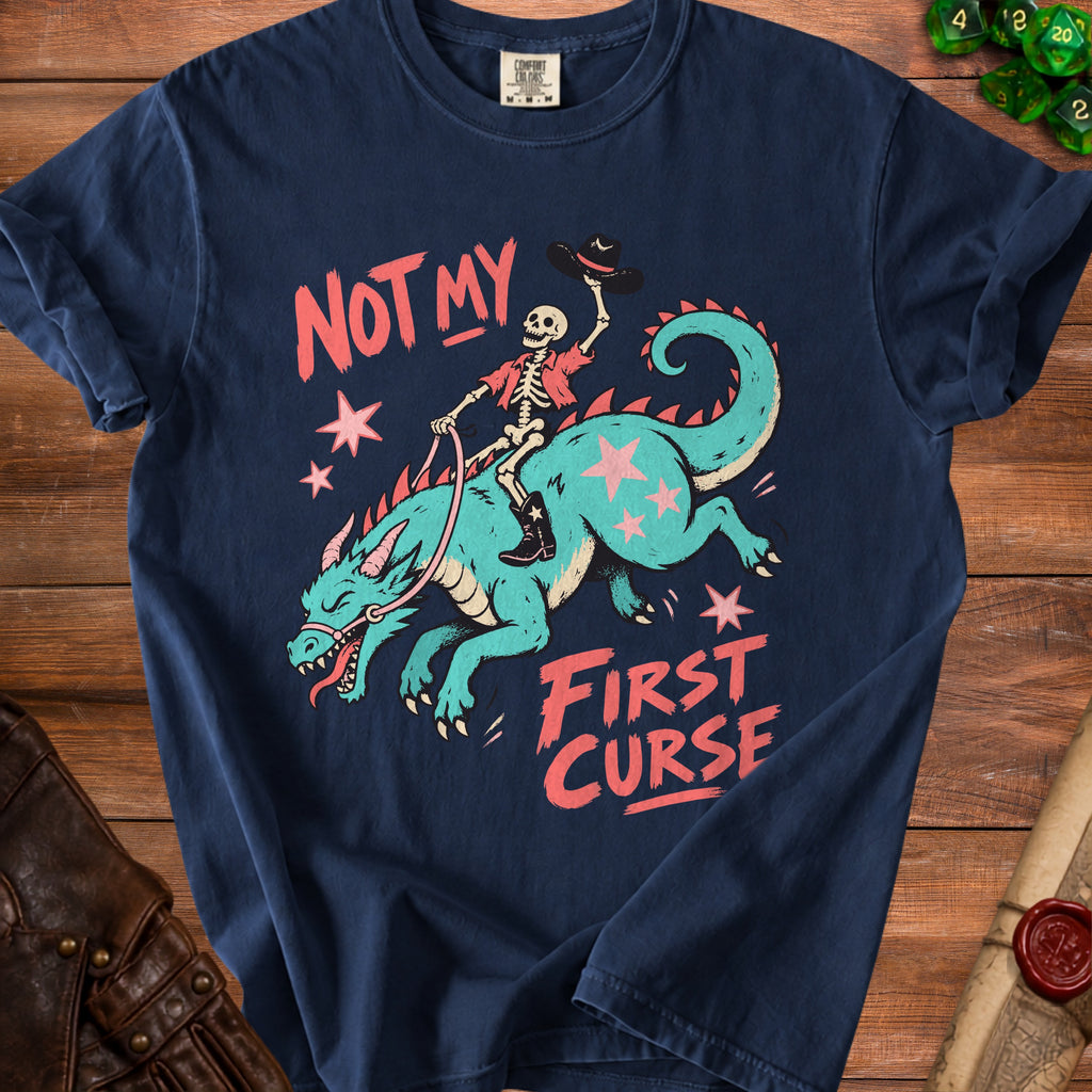 Dark blue t-shirt with skeleton riding a teal dragon graphic that says "NOT MY FIRST CURSE".