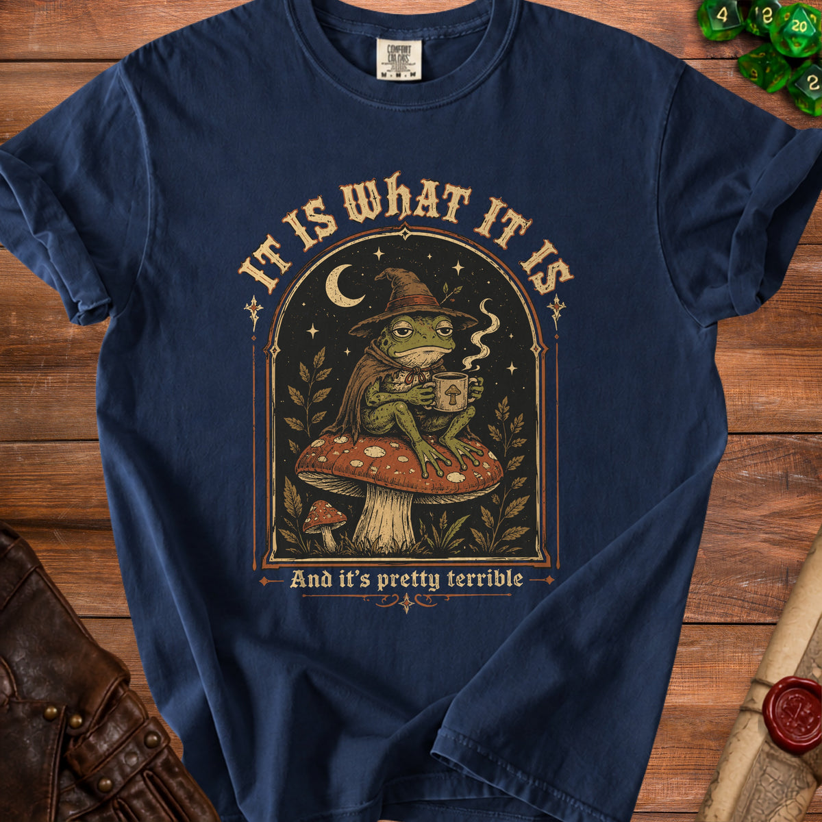 Navy t-shirt with wizard frog holding coffee mug, text "It is what it is And it's pretty terrible".