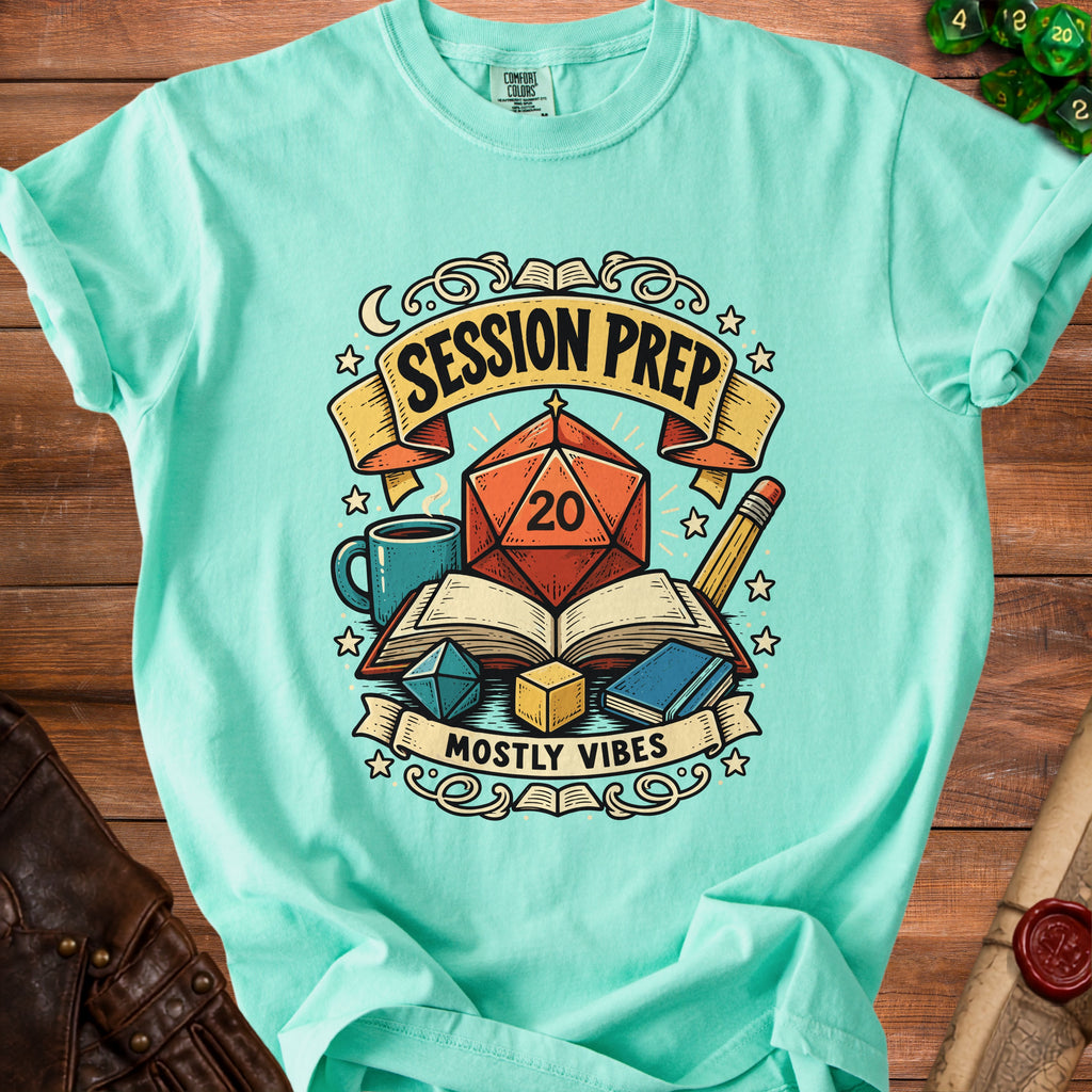 Teal t-shirt graphic with dice, books, and text "SESSION PREP MOSTLY VIBES."