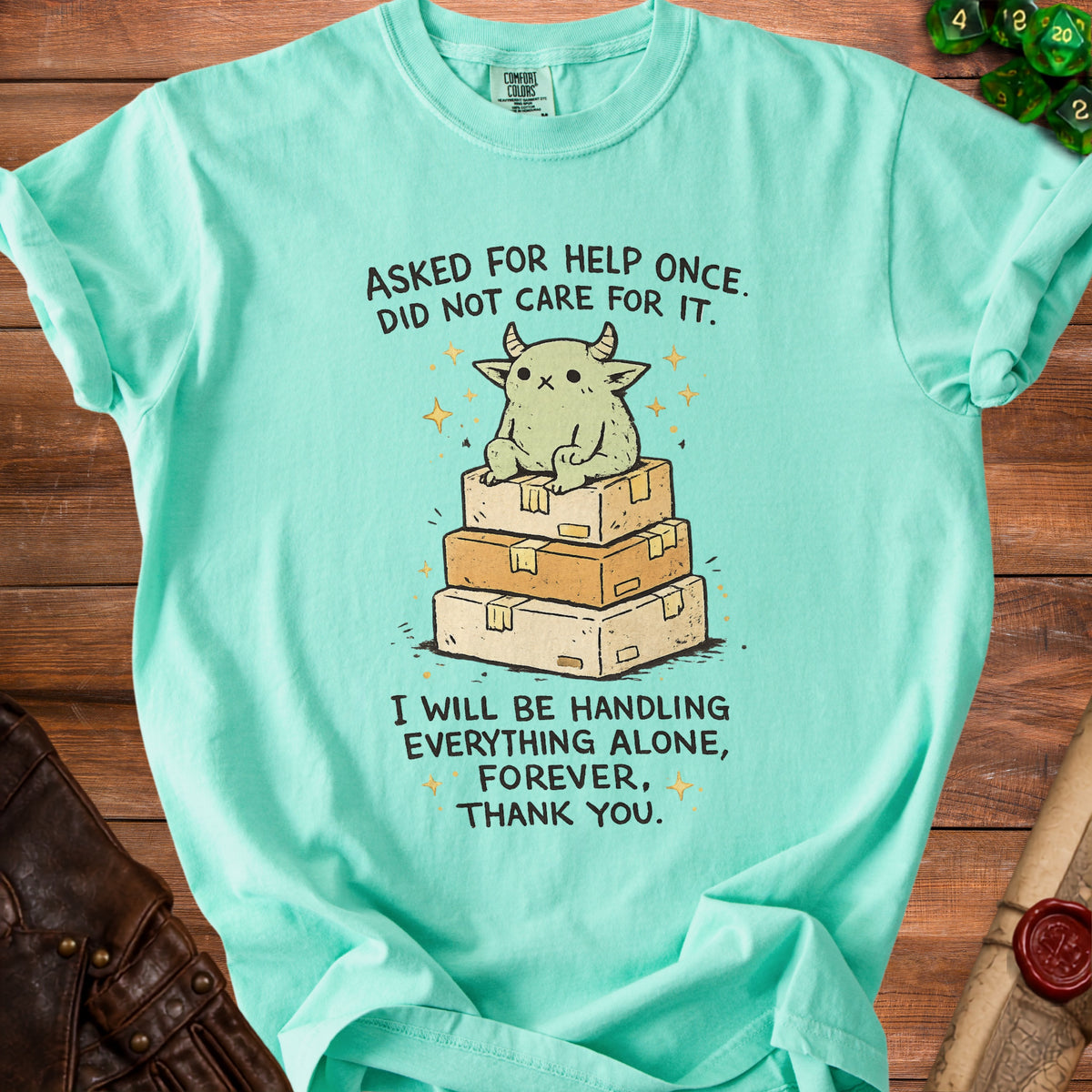 Mint green t-shirt with cartoon monster on boxes text "I will be handling everything alone".