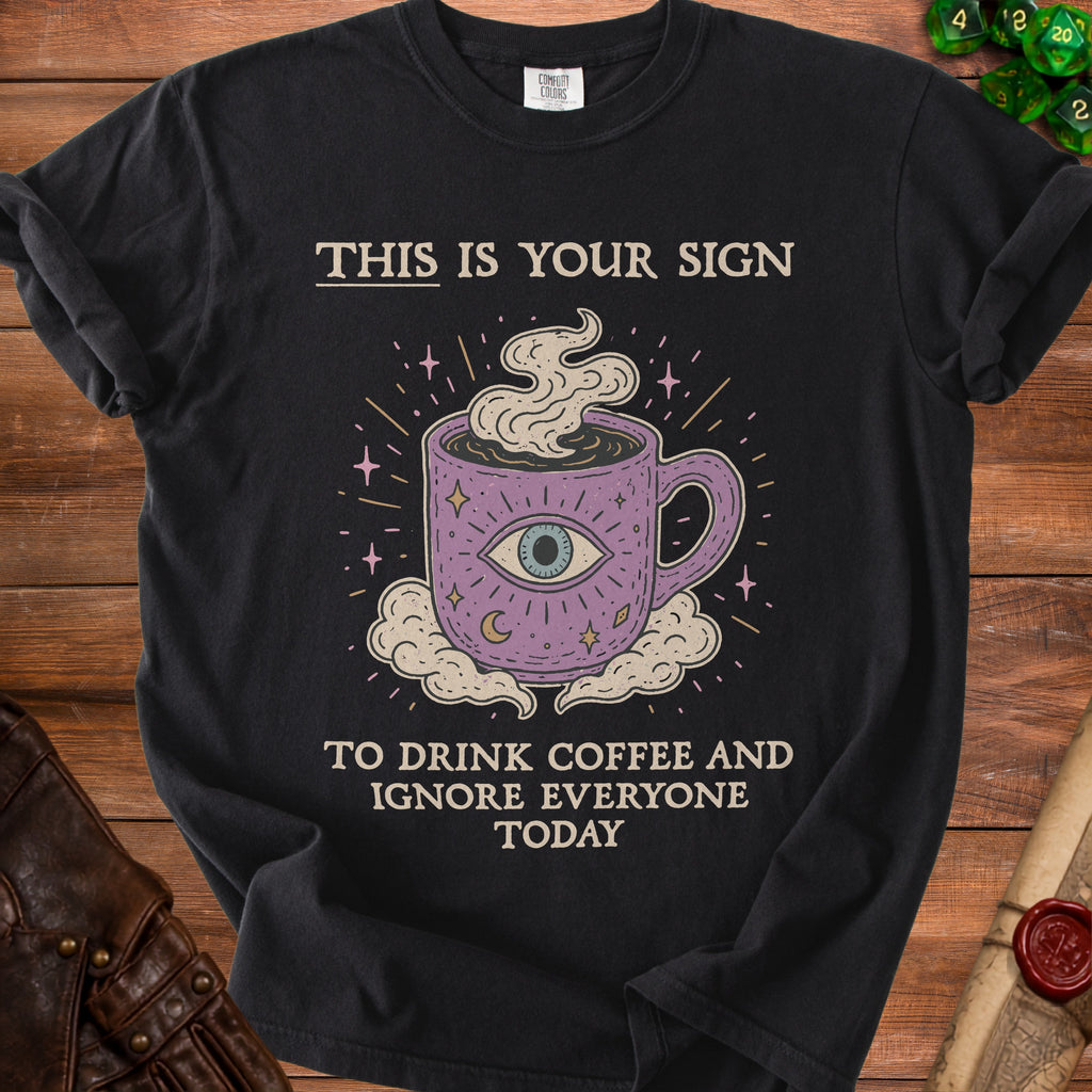 Black t-shirt with a mystical coffee mug and text, "This is your sign to drink coffee and ignore everyone today."