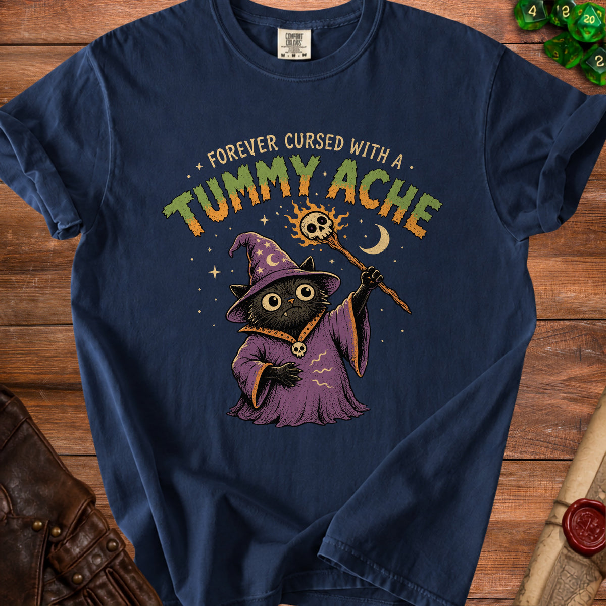 Navy t-shirt with a black cat wizard graphic that reads "Forever Cursed with a Tummy Ache."