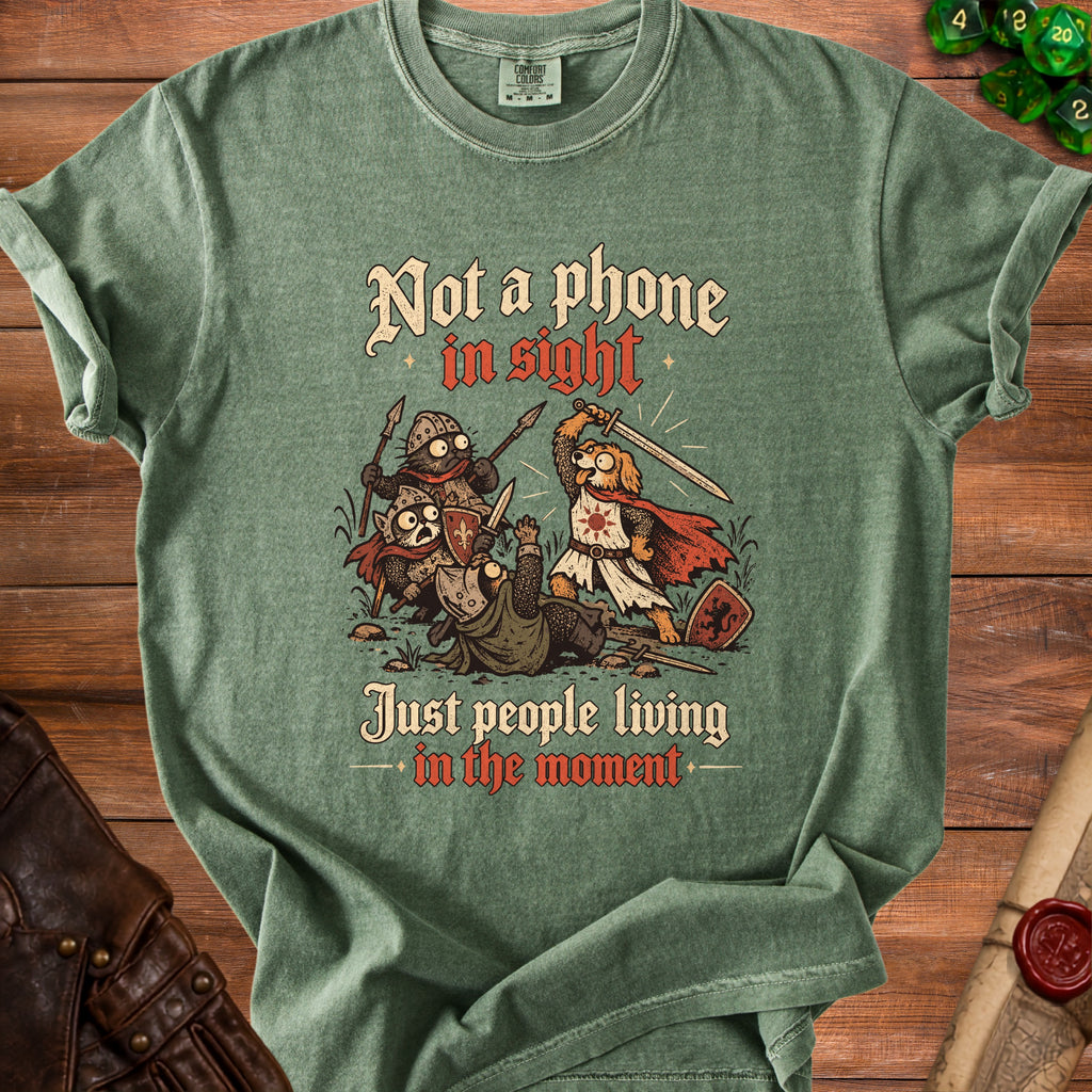 Green t-shirt with "Not a phone in sight, Just people living in the moment" and cartoon knights.
