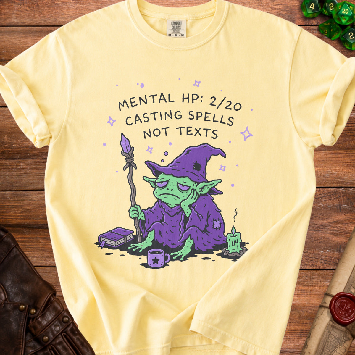 Yellow t-shirt with graphic of tired goblin wizard, "Mental HP: 2/20 Casting Spells Not Texts."