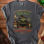 Dark gray t-shirt with frog witch graphic and text "I Yearn for the Bog Become Ungovernable."