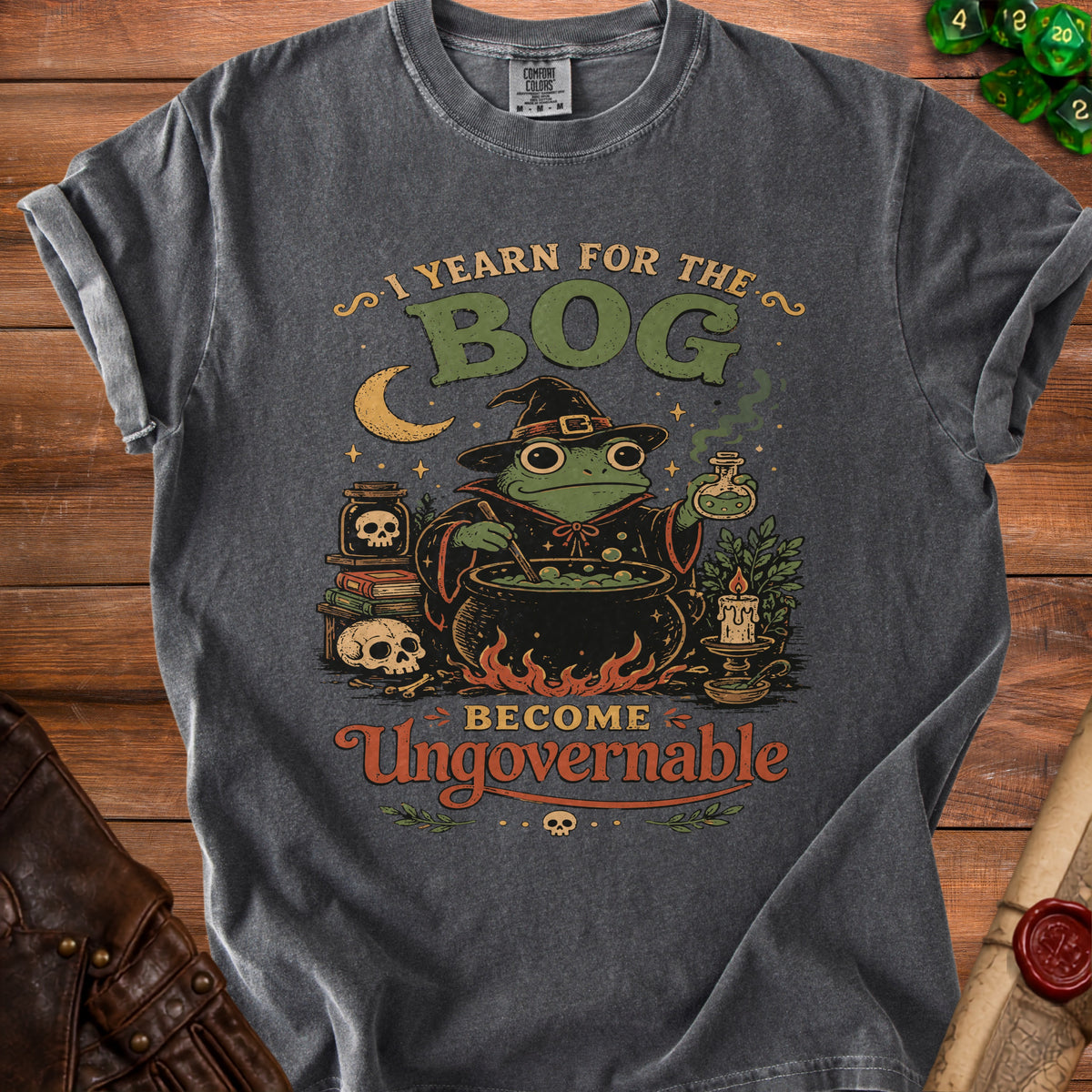 Dark gray t-shirt with frog witch graphic and text "I Yearn for the Bog Become Ungovernable."
