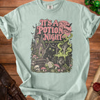 Light mint t-shirt with "It's a Potion Night, the weirdos are brewing" text and witchy graphic.
