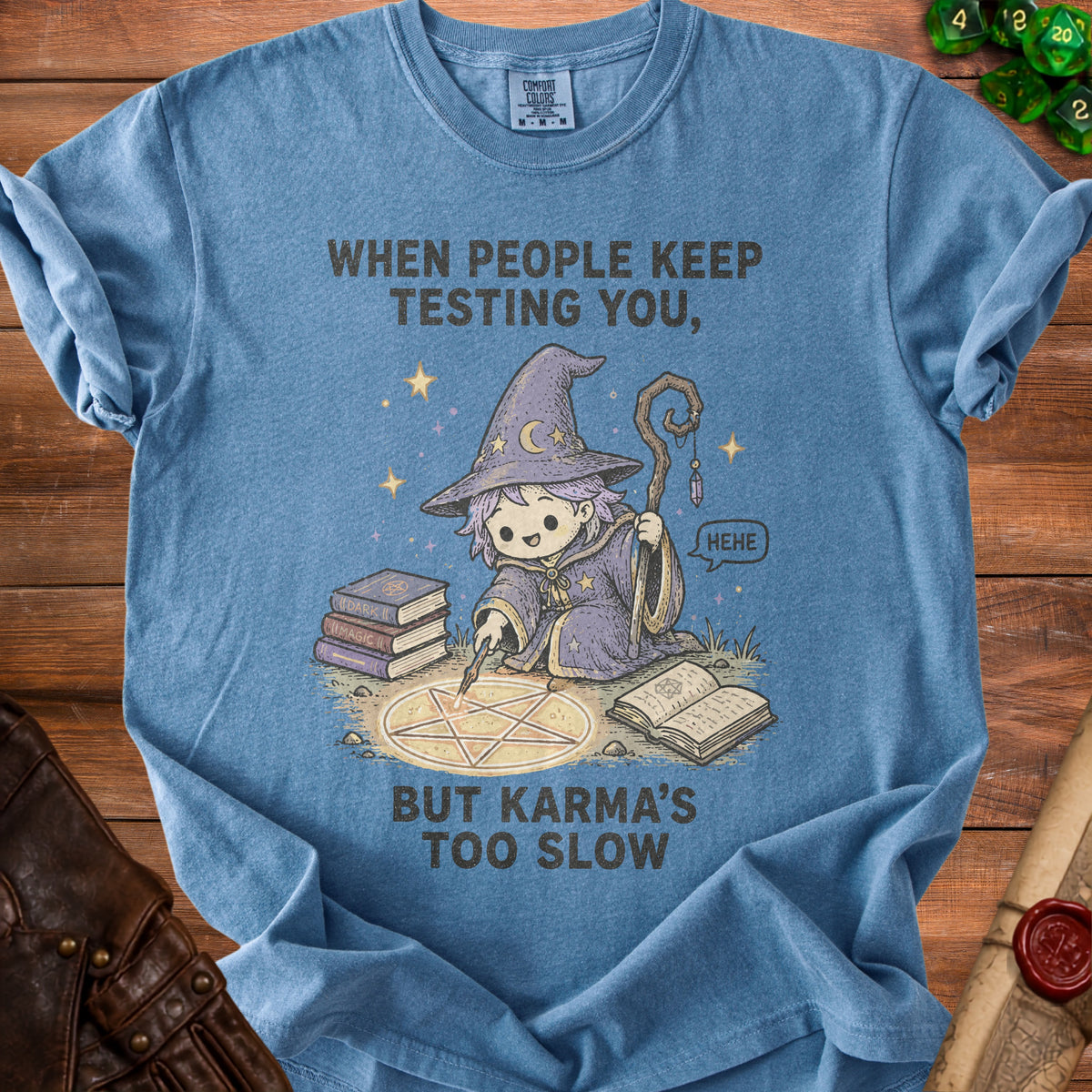 Blue t-shirt with a cartoon wizard casting a spell, text reads "When people keep testing you, but karma's too slow."