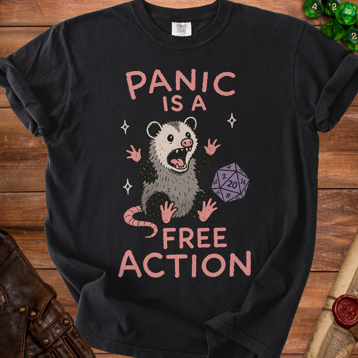 Black t-shirt with a panicked possum and dice, reading "Panic is a free action".