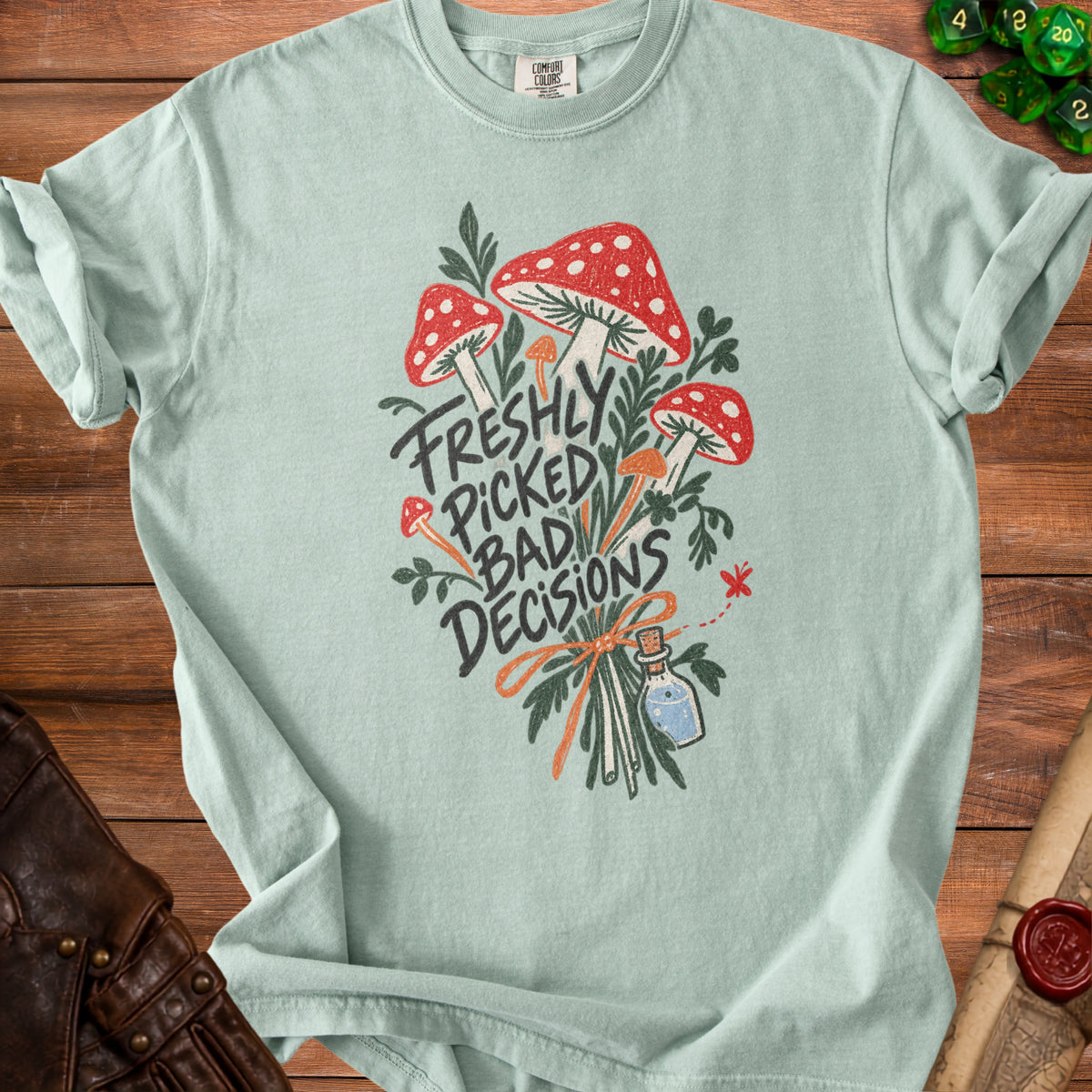 Light blue t-shirt with a graphic of mushrooms and the text "Freshly Picked Bad Decisions".