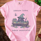 Pink t-shirt with cartoon raven wearing a wizard hat and text "Dragon Slain, Inbox Undefeated".
