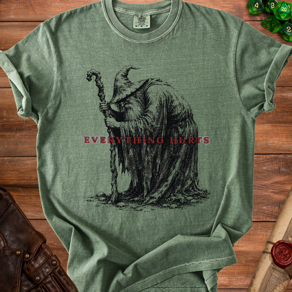 Green t-shirt with black illustration of a wizard and text "EVERYTHING HURTS".