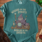 T-shirt graphic: cat wizard with staff and crystal ball, text "Wizard in the Streets Goblin in the Sheets".