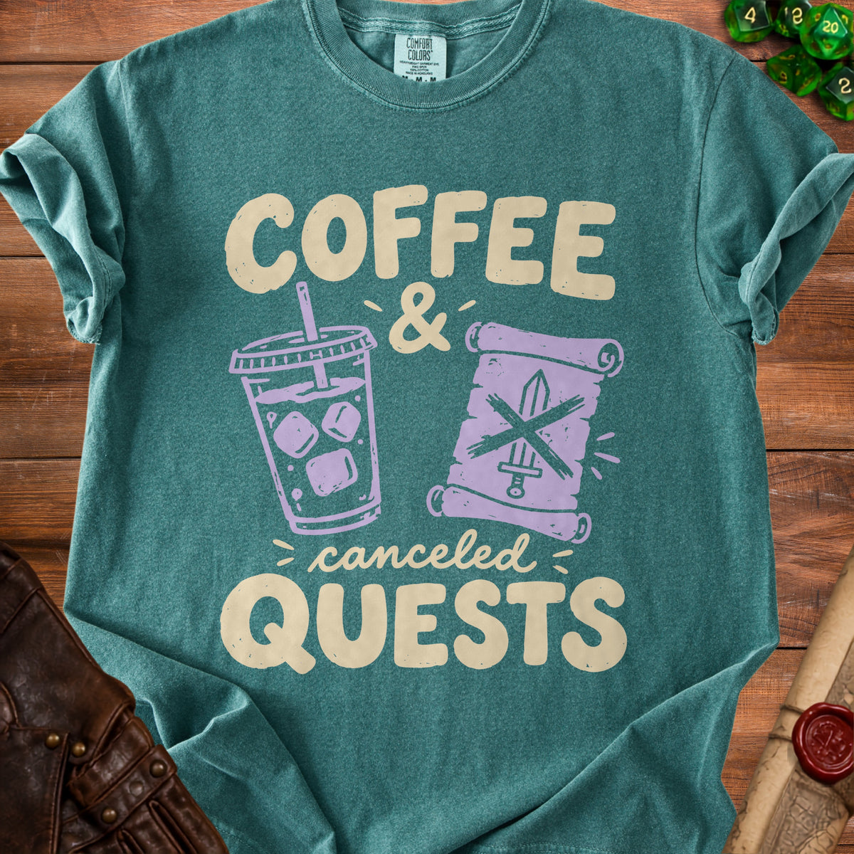 Teal t-shirt with "Coffee & Canceled Quests" text and icons of a drink and sword.