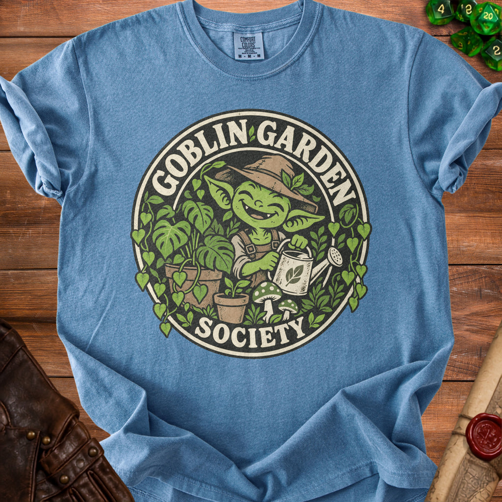Goblin Garden Society graphic on a blue t-shirt featuring a gardening goblin.