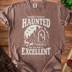 Brown t-shirt with "tonight's forecast HAUNTED but the loot is EXCELLENT" text and Halloween graphics.