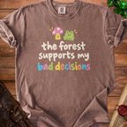 Brown t-shirt with frog, mushroom, and text "the forest supports my bad decisions".