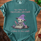 Skeleton in wizard hat writing in a book with text "You call it a criminal record, I call it my lore."