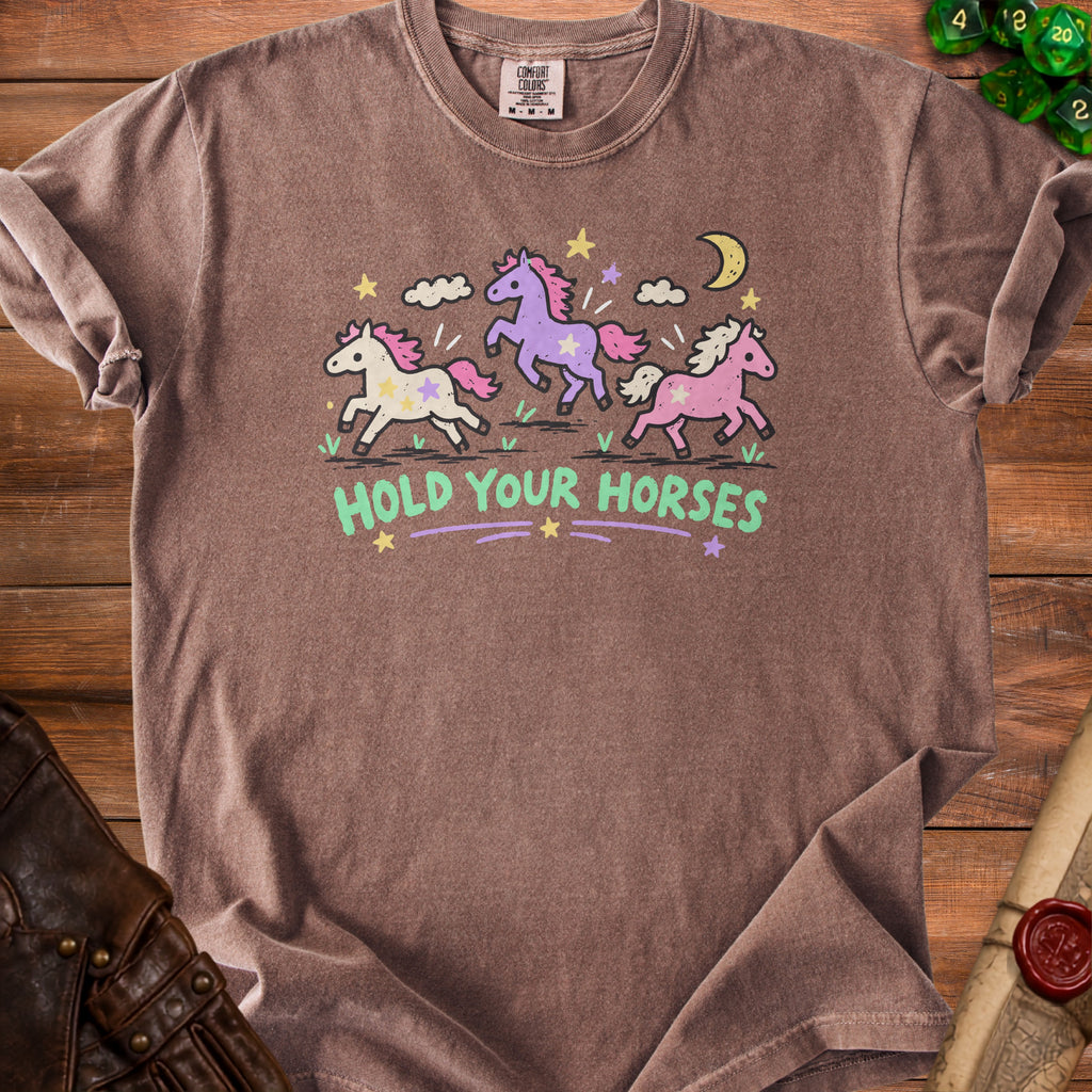 Brown t-shirt with cartoon unicorns and the text "HOLD YOUR HORSES".