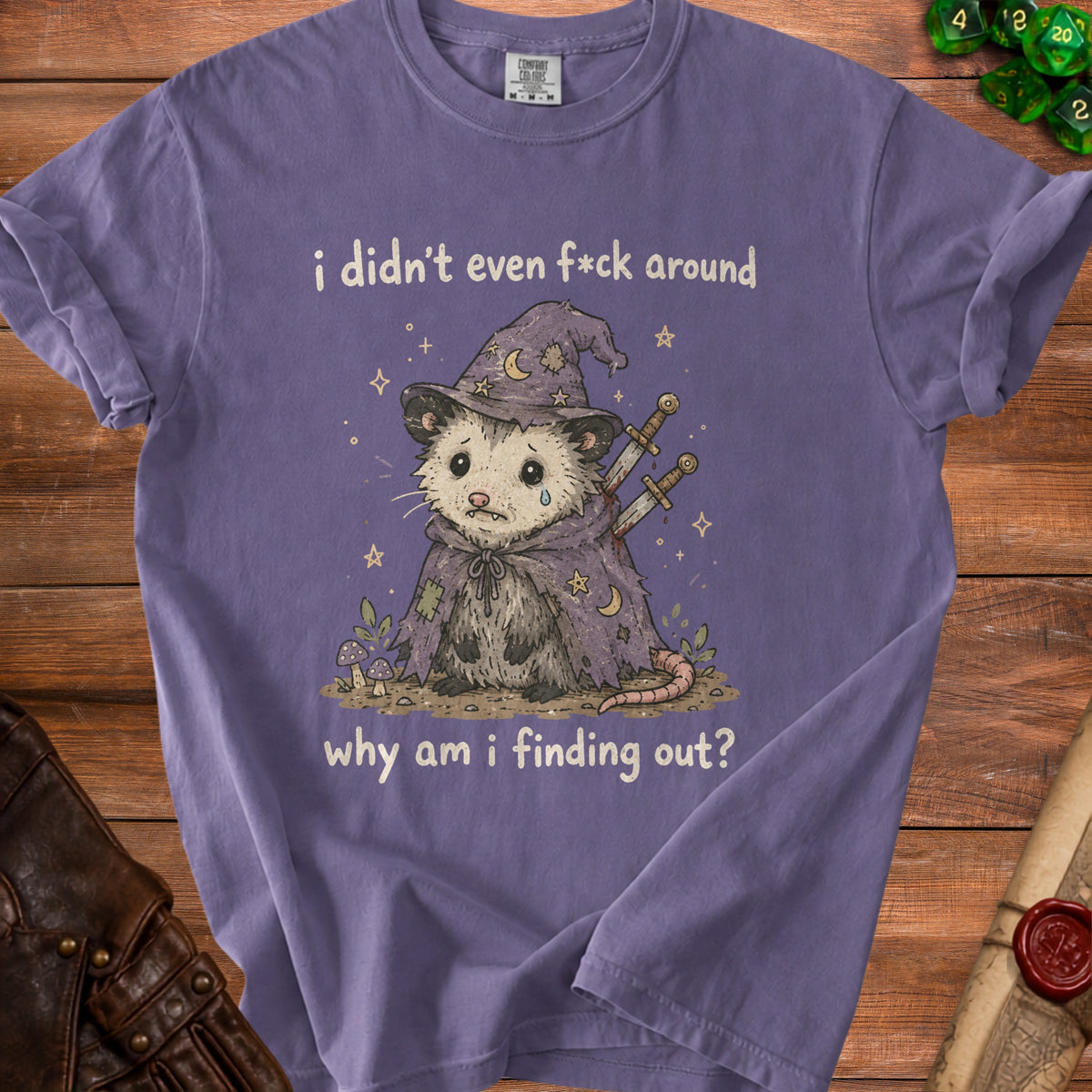 Purple t-shirt with a cartoon possum in wizard garb and text "i didn't even f*ck around why am i finding out?".