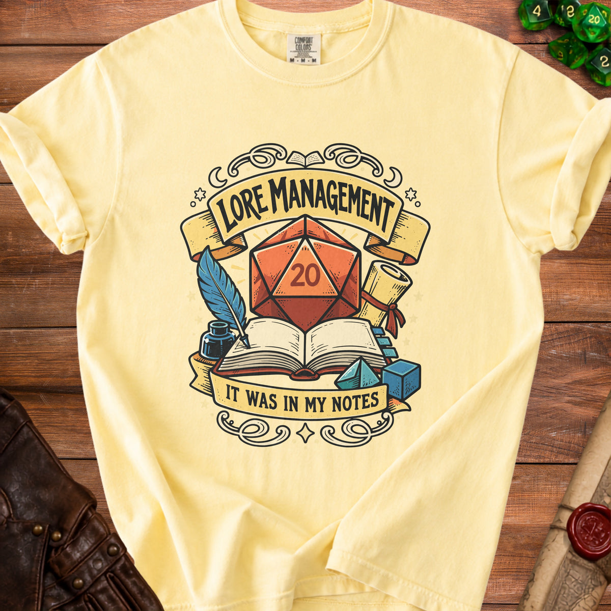 Yellow t-shirt with "Lore Management" design, featuring a d20 die and text "It was in my notes."
