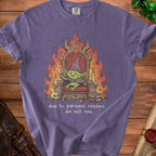 Purple t-shirt with a goblin on a throne surrounded by flames and text.