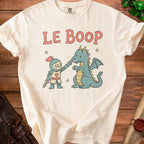 Cream t-shirt with knight booping a dragon, says "LE BOOP".
