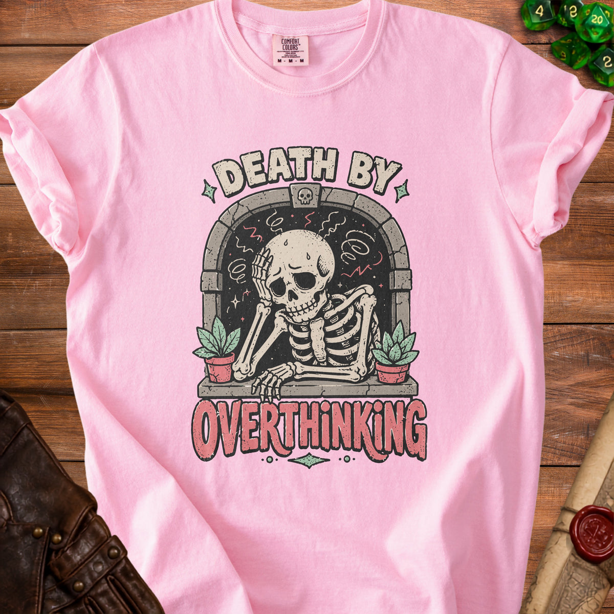Pink t-shirt with skeleton and text "DEATH BY OVERTHINKING" graphic.
