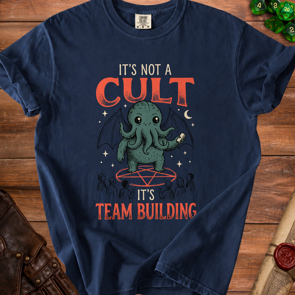 Dark blue t-shirt graphic with text "IT'S NOT A CULT IT'S TEAM BUILDING" and Cthulhu.