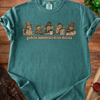 Goblin administrative duties graphic on a teal t-shirt with stacks of paper.
