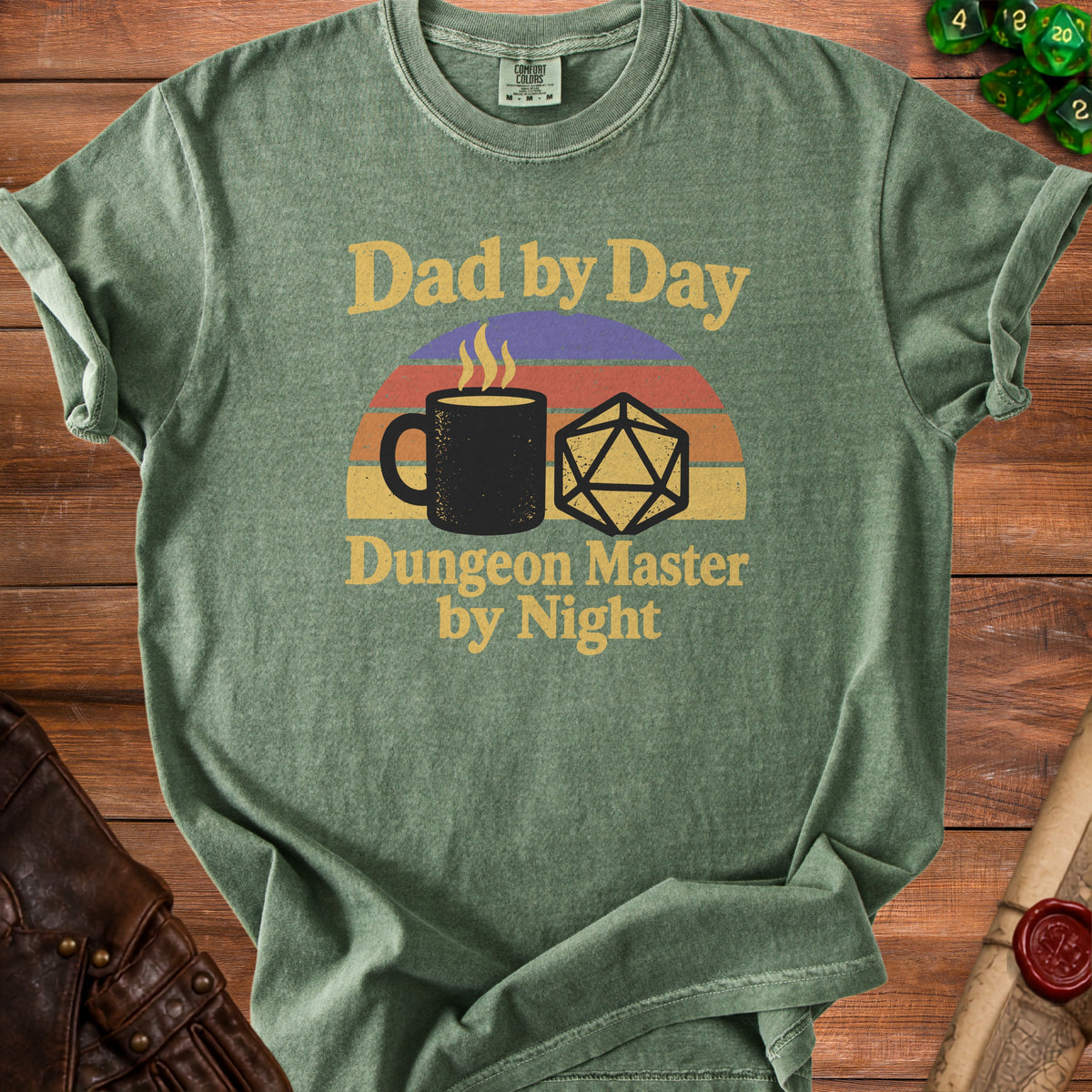 Green t-shirt with "Dad by Day, Dungeon Master by Night" text and dice graphic.