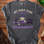 T-shirt with text "MY AURA FARM WAS SHUT DOWN BY THE GOVERNMENT" and goat graphic.