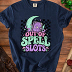 Dark blue t-shirt with "Out of Spell Slots" text and a magical book graphic.