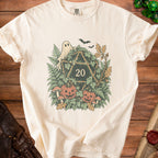 Cream t-shirt with Halloween-themed d20 graphic, featuring ghost, pumpkins, mushrooms, and bats.