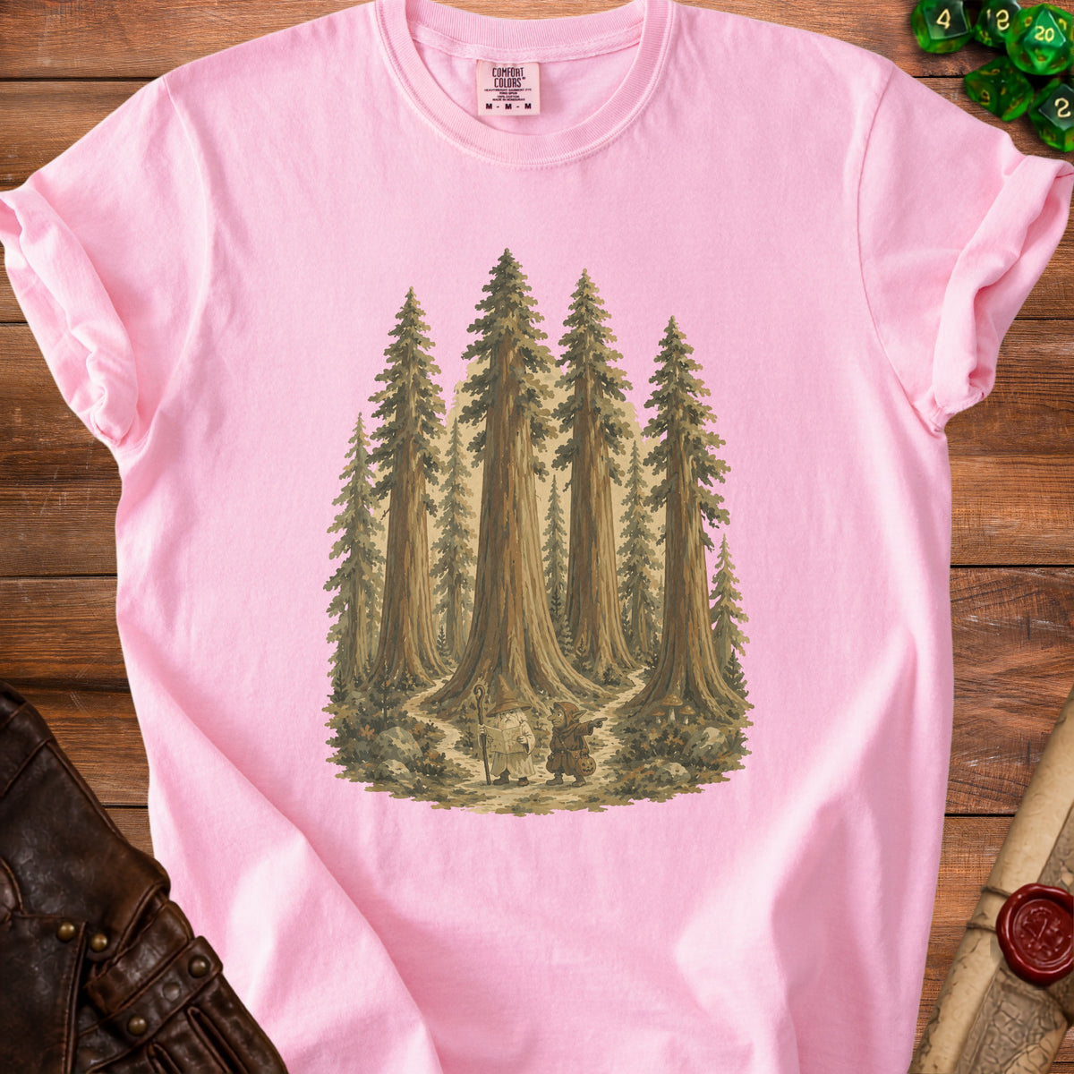 Pink t-shirt with a painting of a wizard and a goblin in a forest.