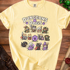 A yellow t-shirt features a Dungeons and Dogs graphic with various cartoon dogs as roleplaying classes surrounding a d20 die.