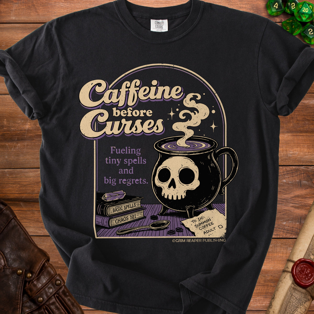 Black t-shirt with "Caffeine before Curses" design and skull cauldron.