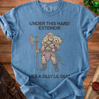 Blue t-shirt with "Under This Hard Exterior Lies a Silly Lil Guy" and barbarian illustration.