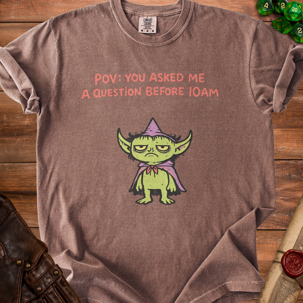 Brown t-shirt with a grumpy goblin and text "POV: YOU ASKED ME A QUESTION BEFORE 10AM".