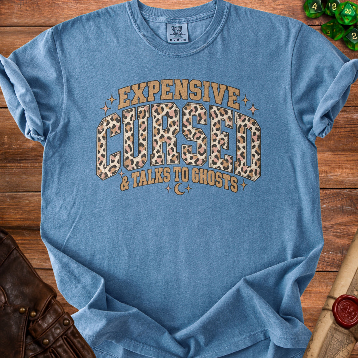 Blue t-shirt with "Expensive Cursed & Talks To Ghosts" text and leopard print.