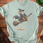 Light green t-shirt with a wizard flying on a broomstick, with dust clouds below.