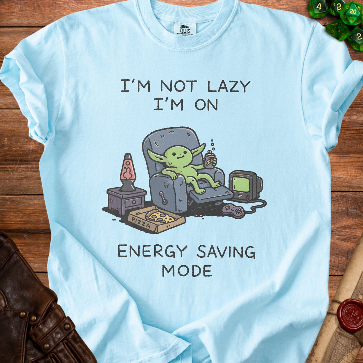 Light blue t-shirt with a graphic of a goblin sitting in a recliner, saying "I'm not lazy, I'm on energy saving mode."