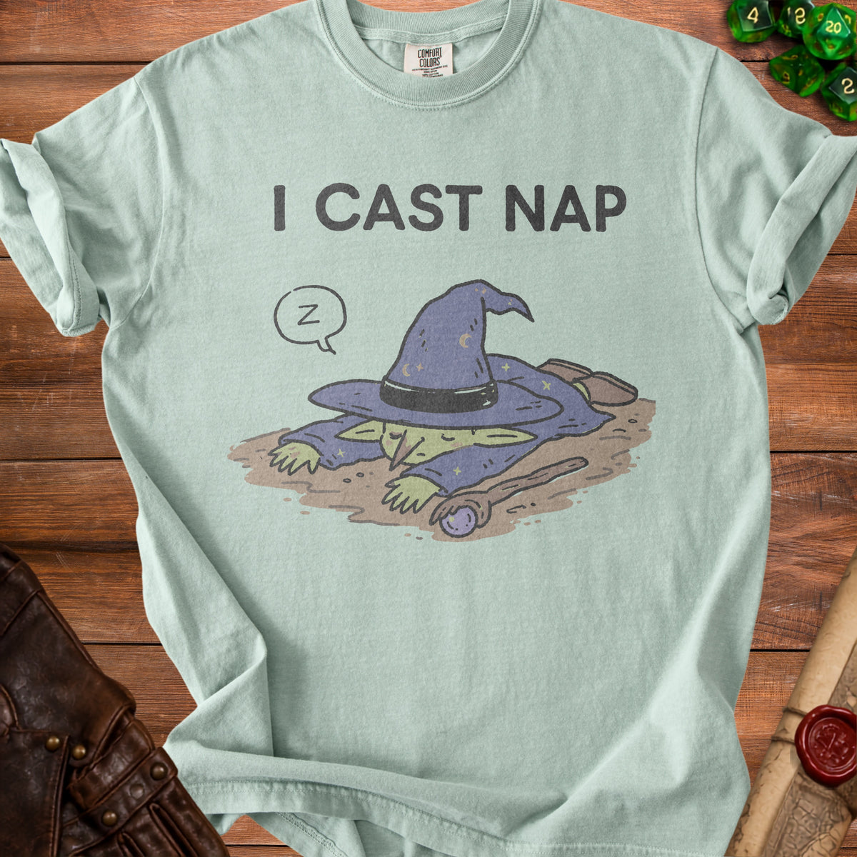 Light green t-shirt with a sleeping wizard graphic and "I CAST NAP" text.
